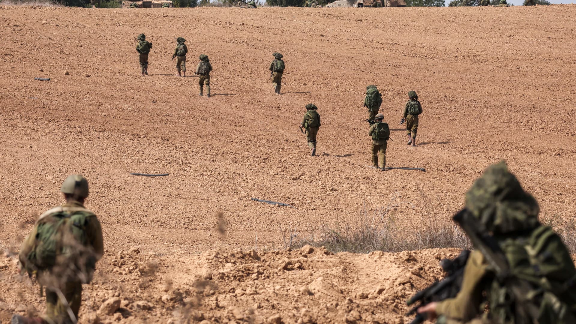 Israeli soldiers take up position in Kfar Aza, in the south of Israel, bordering Gaza Strip on October 10, 2023. Israel pounded Hamas targets in Gaza on October 10 and said the bodies of 1,500 Islamist militants were found in southern towns recaptured by the army in gruelling battles near the Palestinian enclave. (Photo by Thomas COEX / AFP) (Photo by THOMAS COEX/AFP via Getty Images)