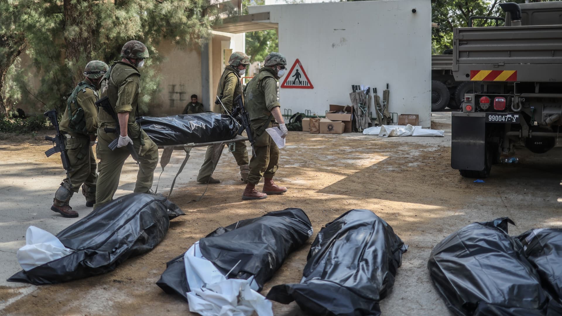 Israeli forces extracting dead bodies of Israeli residents from a destroyed house as fighting between Israeli troops and Islamist Hamas militants continues. 