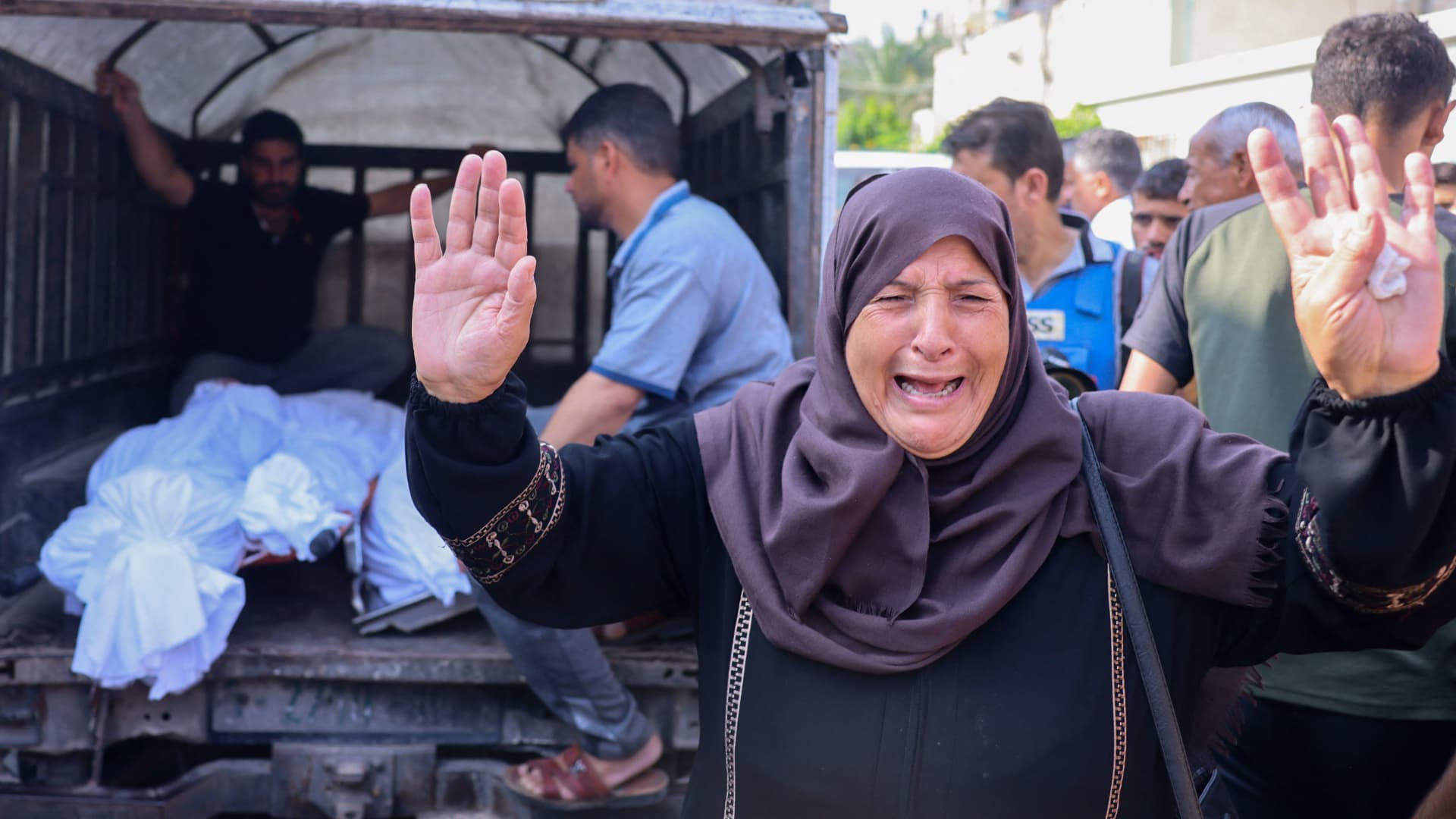 A Palestinian woman reacts as bodies of people killed in overnight Israeli shelling arrive for their funeral in Khan Yunis in the southern Gaza Strip, on October 10, 2023. 