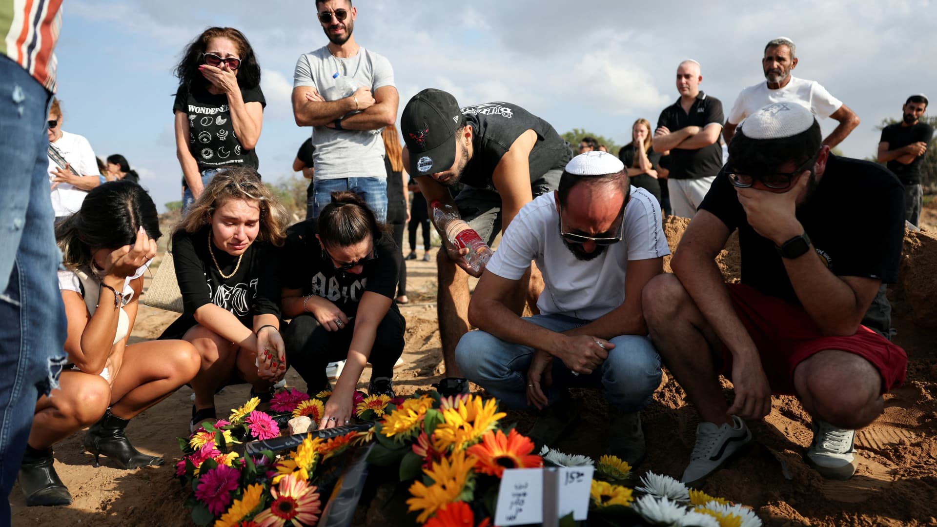 People mourn at the graveside of Eden Guez, who was killed as she attended a festival that was attacked by Hamas gunmen from Gaza that left at least 260 people dead, at her funeral in Ashkelon, in southern Israel, October 10, 2023.