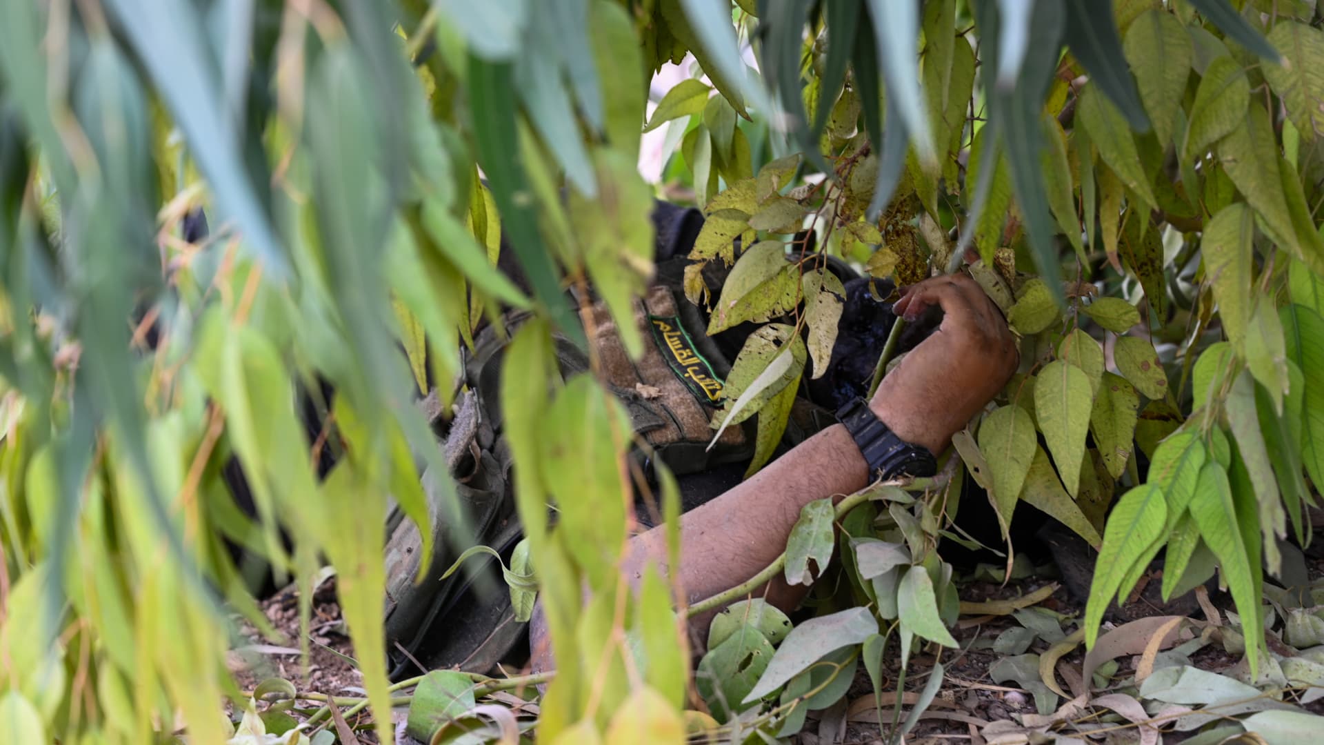 KFAR AZA, ISRAEL - OCTOBER 10: (EDITOR'S NOTE: Image depicts death.) The body of a dead Hamas militant who hid in the bushes lies on the ground at the kibbutz Kfar Aza on October 10, 2023 in Kfar Aza, Israel.