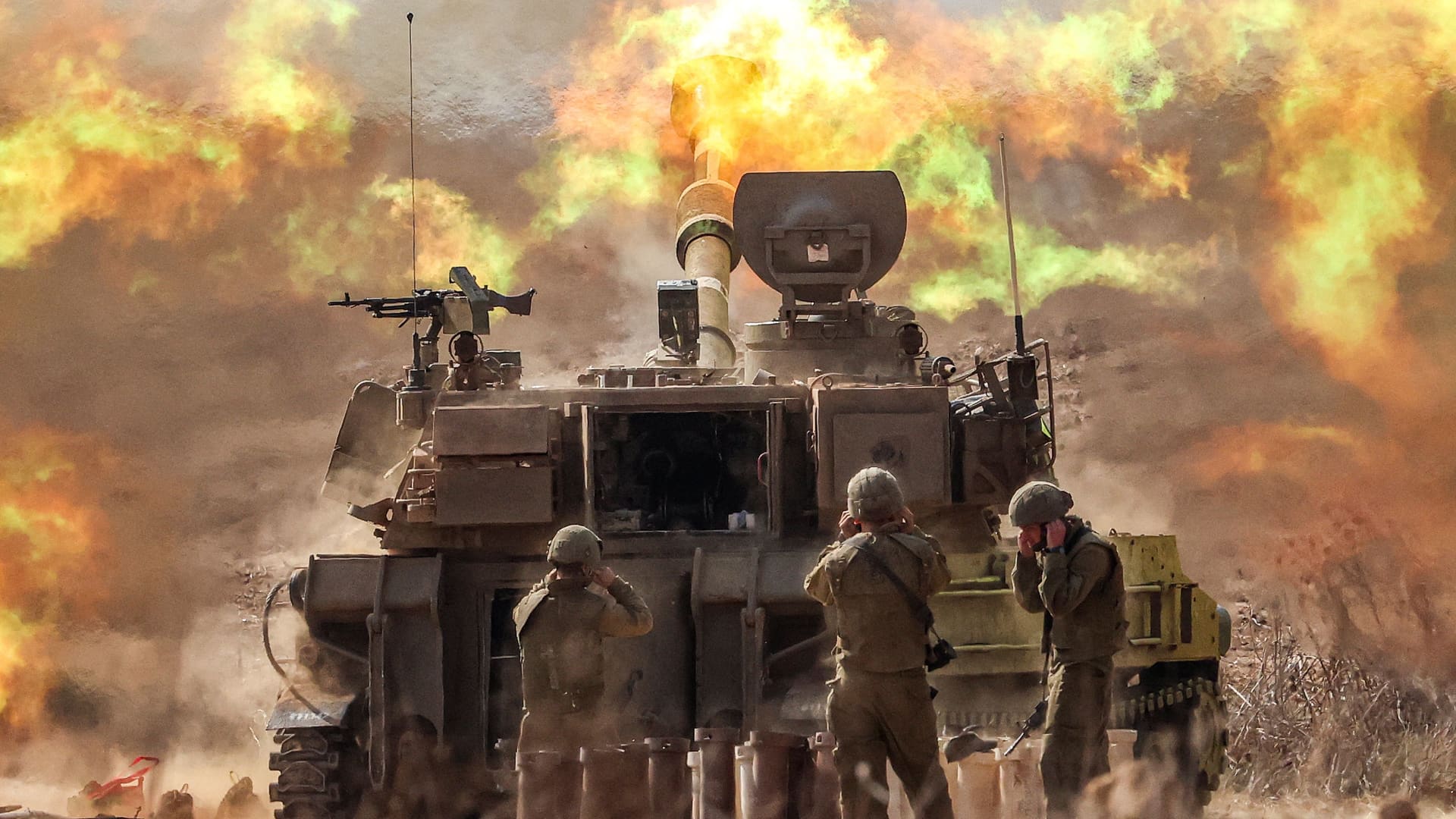 An Israeli army self-propelled howitzer fires rounds near the border with Gaza in southern Israel on Oct. 11, 2023.