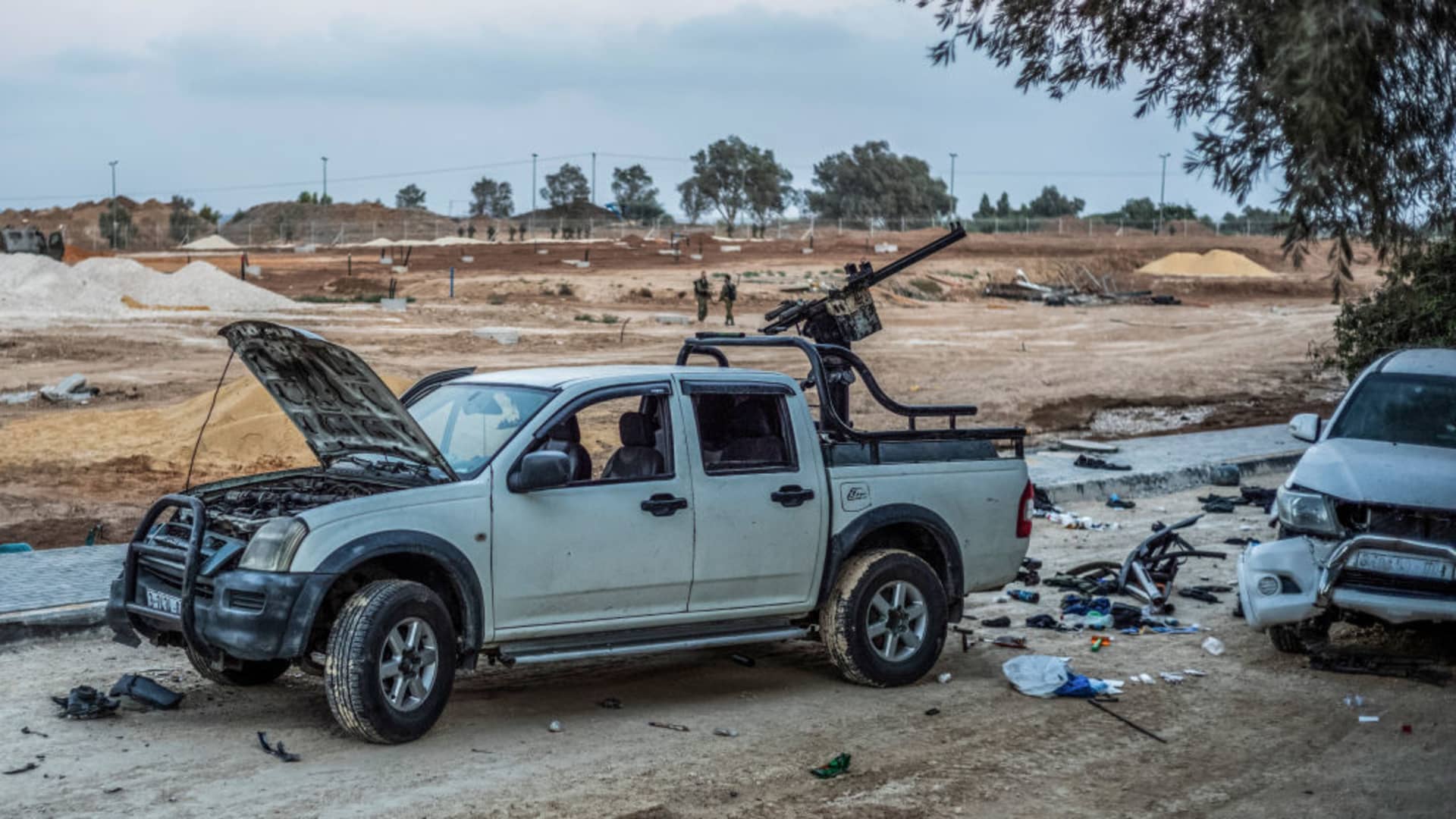 A destroyed pickup truck mounted with machine guns, used by Hamas militants in their attack on Kibbutz Be'eri, lies in the rubble after the Israeli army regained control.