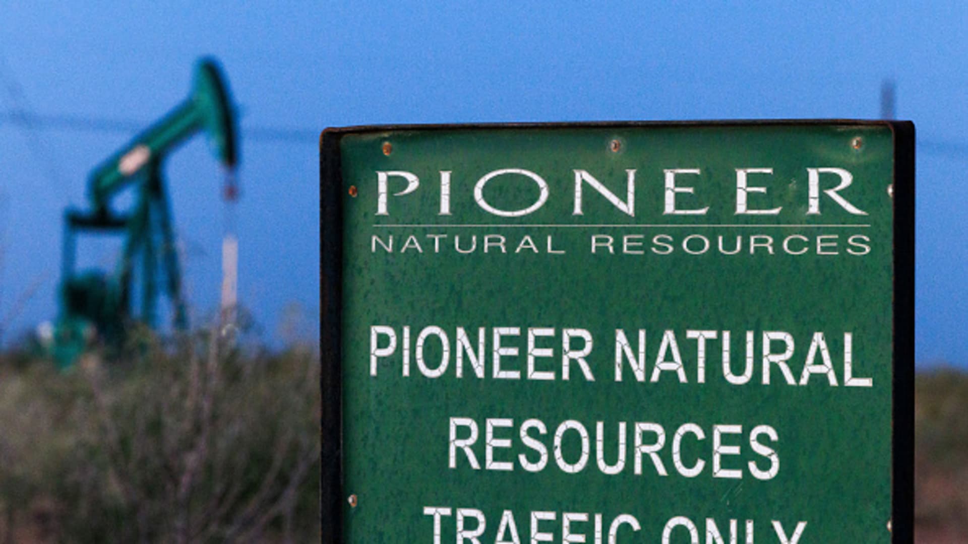 A sign near a Pioneer Natural Resources well near Midland, Texas, US, on Wednesday, Oct. 11, 2203.