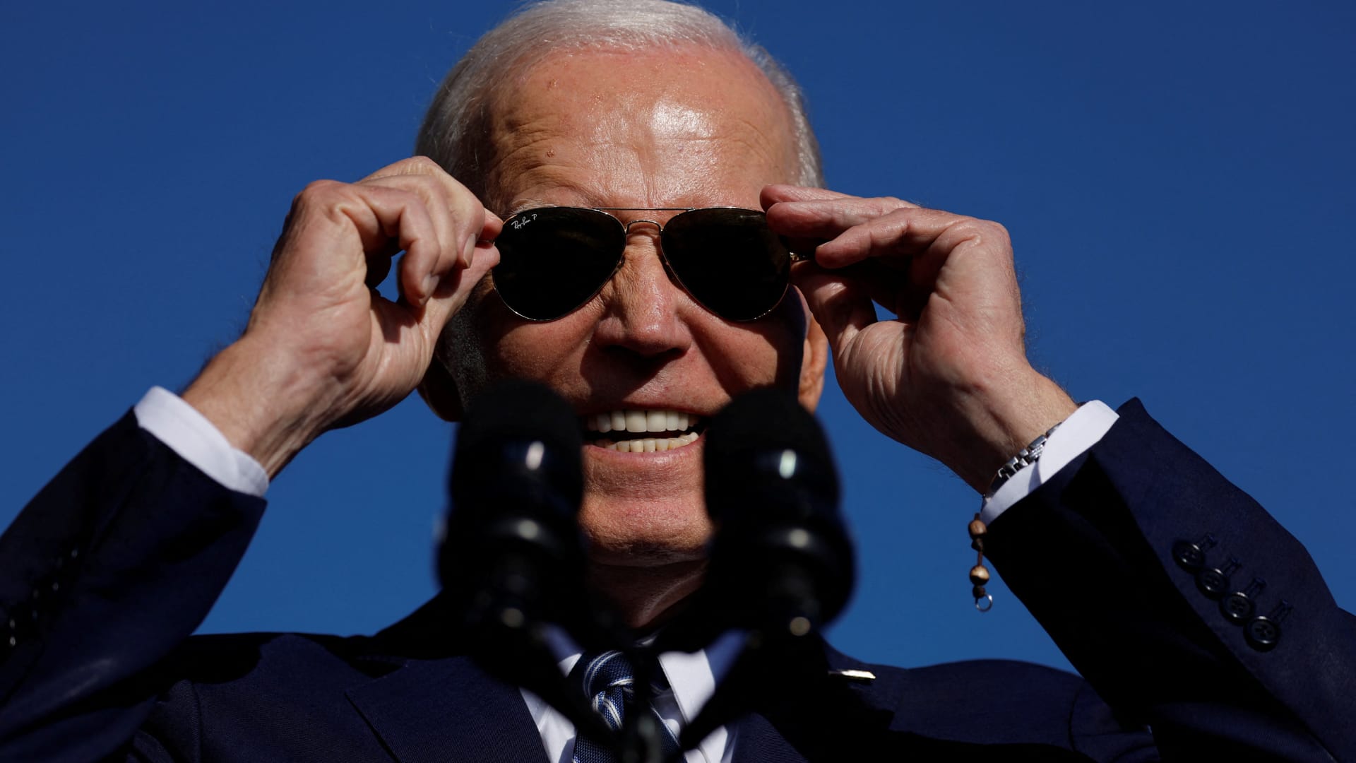 U.S. President Joe Biden adjusts his sunglasses as he delivers remarks on his economic objectives at the Tioga Marine Terminal in Philadelphia, Pennsylvania, October 13, 2023.