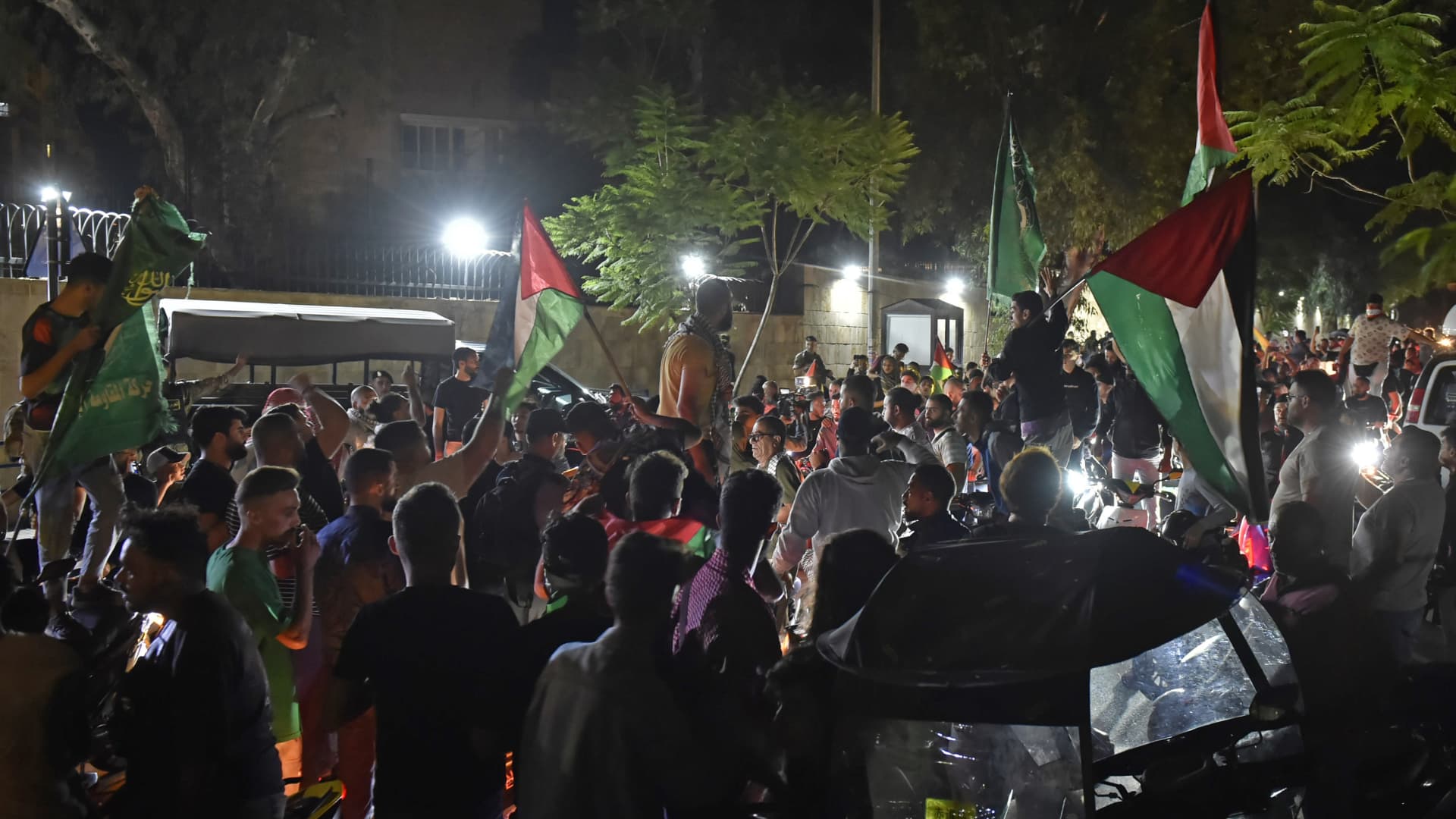 People stage a protest against Israeli airstrike on Gaza's Al-Ahli Baptist Hospital, with Palestinian flags in hands, in front of the French Embassy building in Beirut, Lebanon on October 17, 2023.