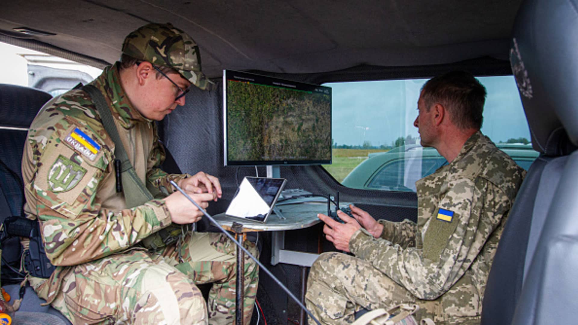 Servicemen examine the territory with the help of a drone.