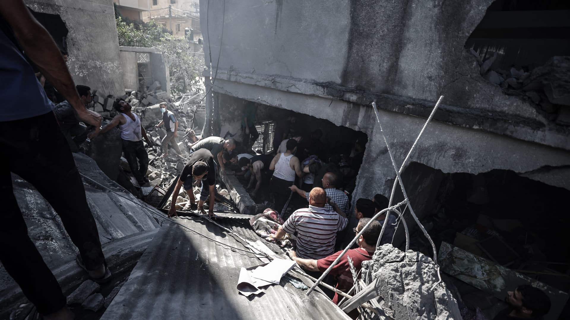 Teams conduct search and rescue operations after Israeli airstrikes in Gaza City, Gaza on October 18, 2023.