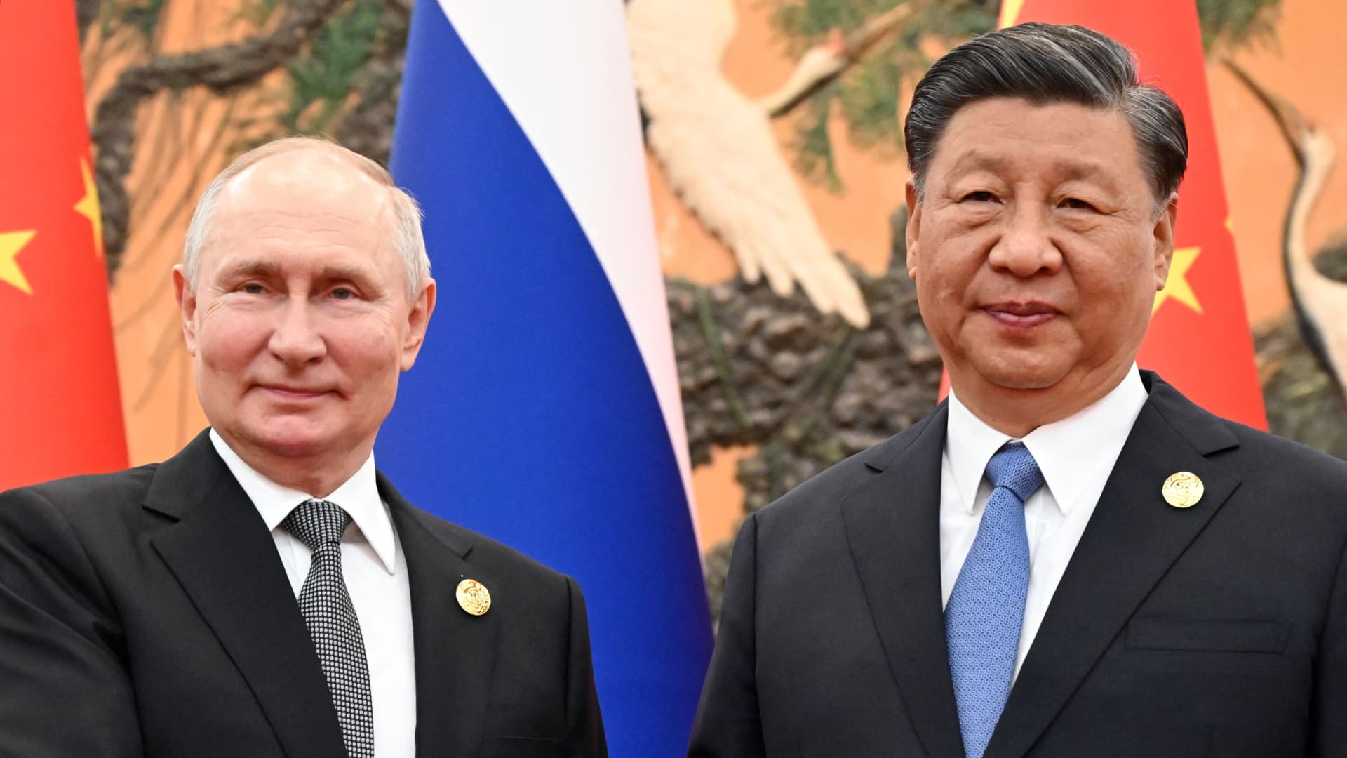This pool photograph distributed by Russian state owned agency Sputnik shows Russia's President Vladimir Putin and Chinese President Xi Jinping posing during a meeting in Beijing on October 18, 2023.