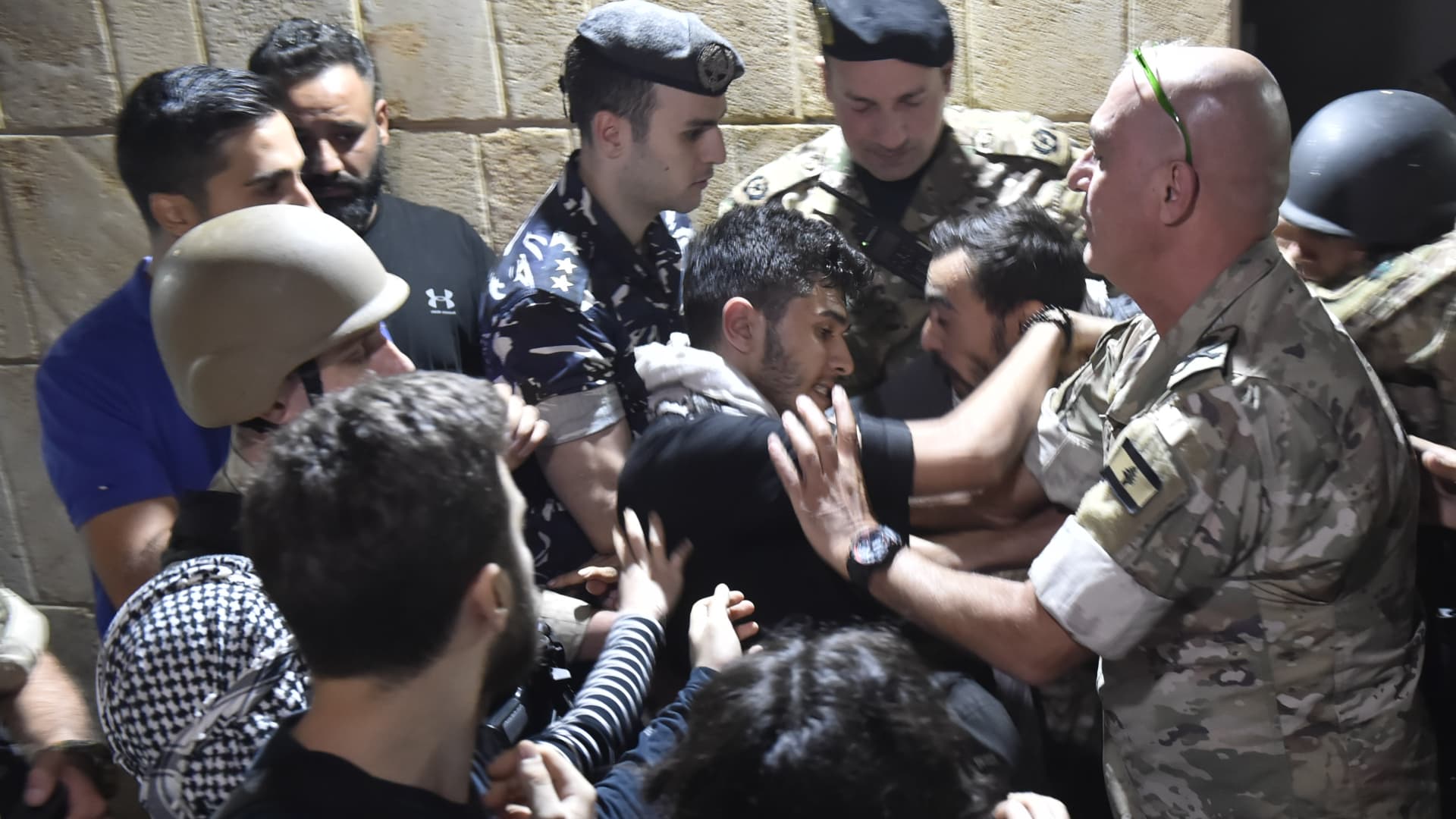 Lebanese police and soldiers intervene in the protest after a blast at Al-Ahli Baptist Hospital in Gaza, staged in front of the French Embassy building in Beirut, Lebanon on October 17, 2023. (Photo by Houssam Shbaro/Anadolu via Getty Images)