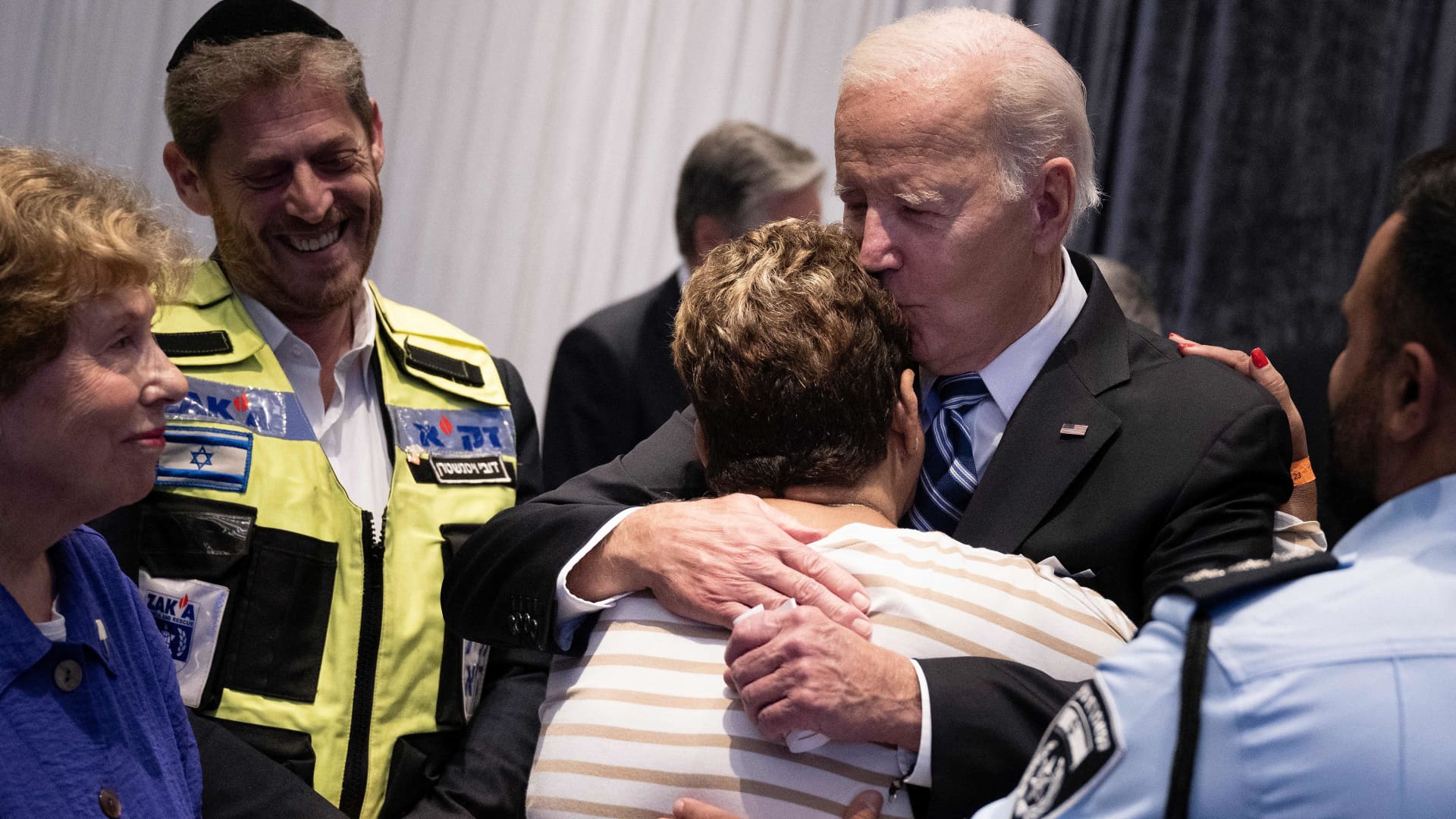 Police officer Evyatar Edri looks on as U.S. President Joe Biden hugs Edri's mother, Rachel Edri, who was held hostage by the Palestinian militant group Hamas, while Biden meets with people affected by the recent Hamas attack on Israel, in Tel Aviv, Oct. 18, 2023.