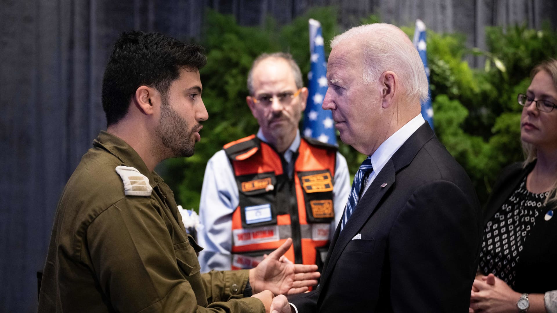 U.S. President Joe Biden speaks with Capt. Maor Farid, left, while meeting with people affected by the Palestinian militant group Hamas' recent attacks on Israel, in Tel Aviv, Oct. 18, 2023.
