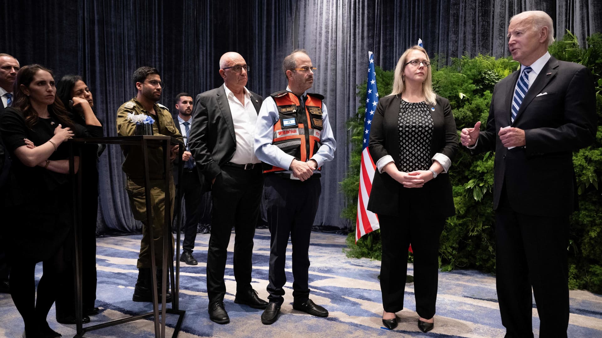 U.S. Charge d'affaires to Israel Stephanie Hallett, second from right, and others listen while U.S. President Joe Biden speaks after meeting with people affected by the Palestinian militant group Hamas' recent attacks on Israel, in Tel Aviv, Oct. 18, 2023.