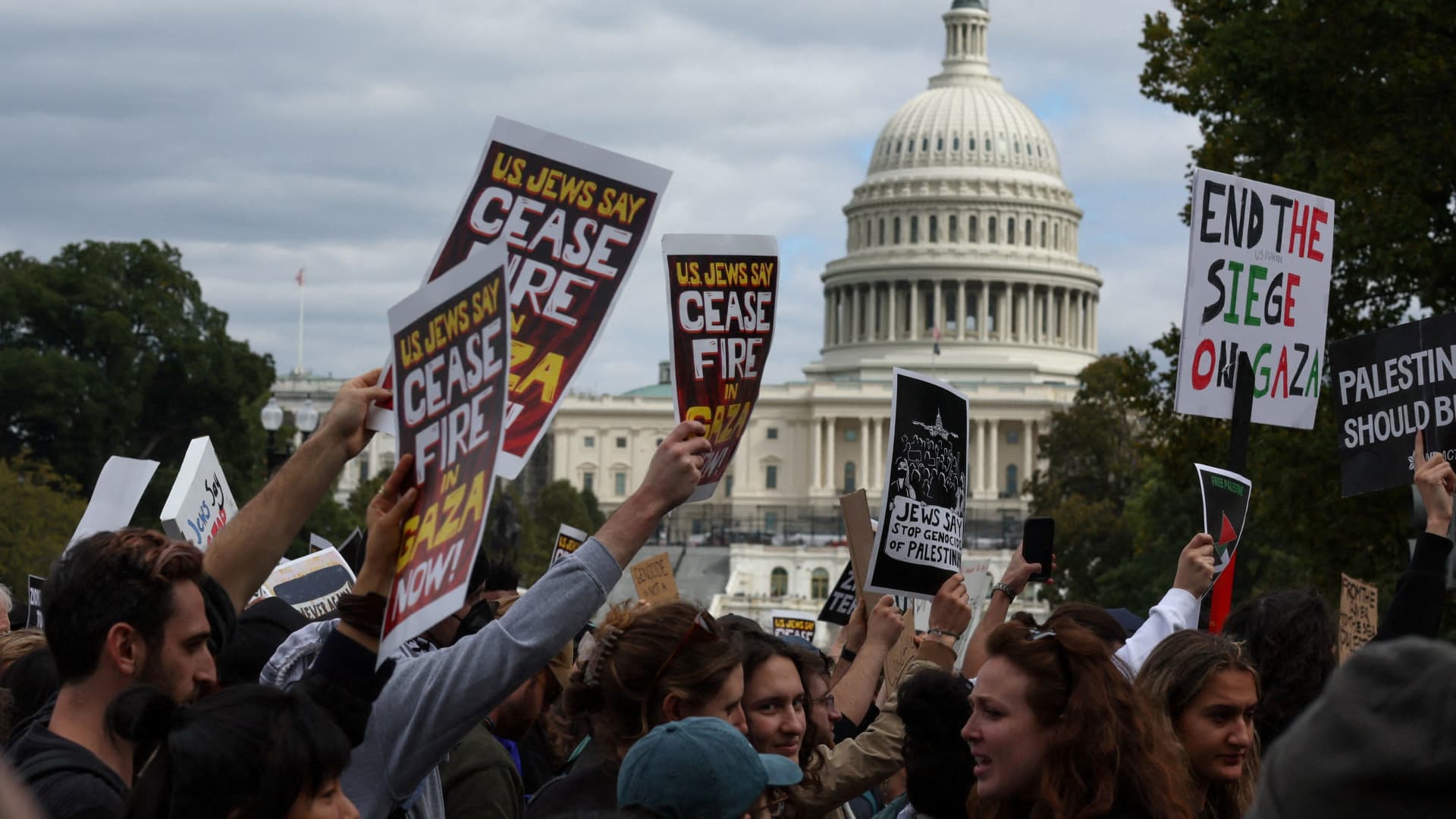 Protesters march past the U.S. Capitol building as they take part in a protest calling for a ceasefire in Gaza, in Washington, October 18, 2023.