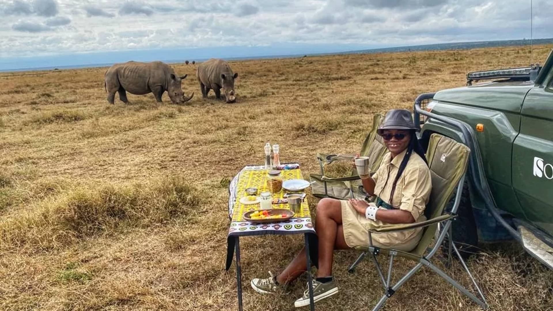 Harriet Akinyi having a bush breakfast with a view of the rhinos after a game drive in Solio Conservancy in Kenya.