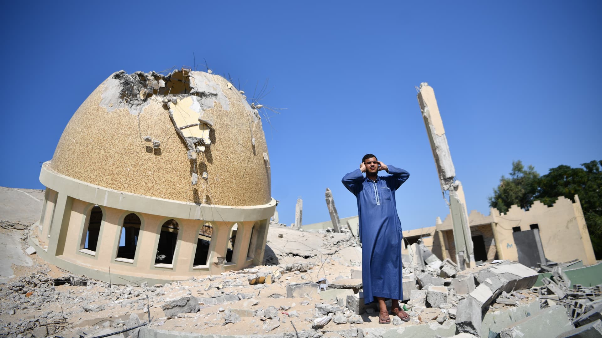 A Palestinian recites Salah Azan (Adhan) in the rubble of the Al-Amin Muhammad Mosque, hit by Israeli airstrike, in Khan Yunis, Gaza on October 20, 2023. 