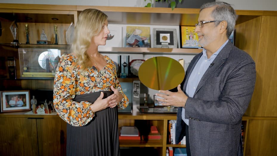 Micron CEO Sanjay Mehrotra shows CNBC's Katie Tarasov a 300mm silicon wafer at the memory company's San Jose office on Oct. 2, 2023.