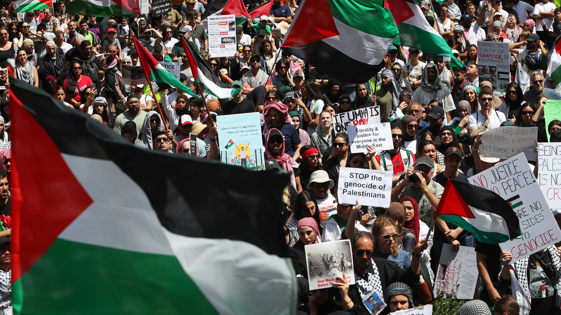 Palestinian supporters gather during a protest at Town Hall on October 21, 2023 in Sydney, Australia.