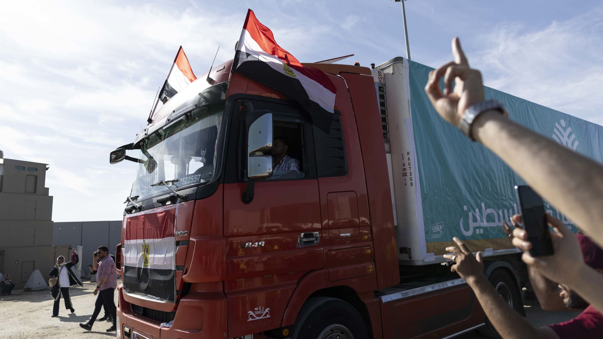 Aid convoy trucks make their way to cross the Rafah border from the Egyptian side on October 21, 2023 in North Sinai, Egypt.