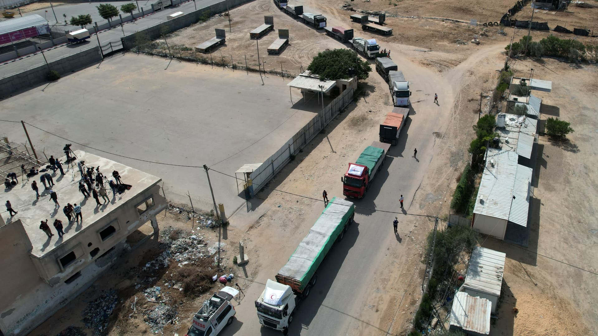 In this aerial view, a convoy of trucks carrying humanitarian aid enters the Gaza Strip from Egypt via the Rafah border crossing on October 21, 2023.