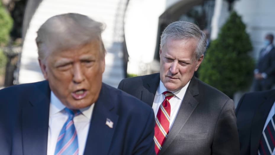 Mark Meadows, White House chief of staff, listens as President Donald Trump, left, speaks to members of the media before boarding Marine One on the South Lawn of the White House in Washington, D.C., July 29, 2020.