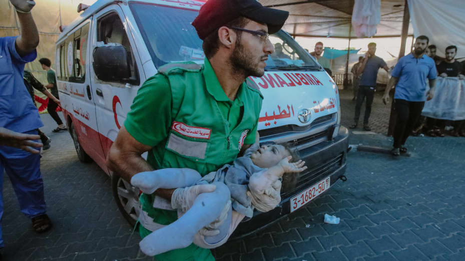 (EDITORS NOTE: Image depicts graphic content) A Red Crescent (Hilal Ahmar) volunteer carries an injured Palestinian child to Al-Shifa Hospital in Gaza following an Israeli airstrike.