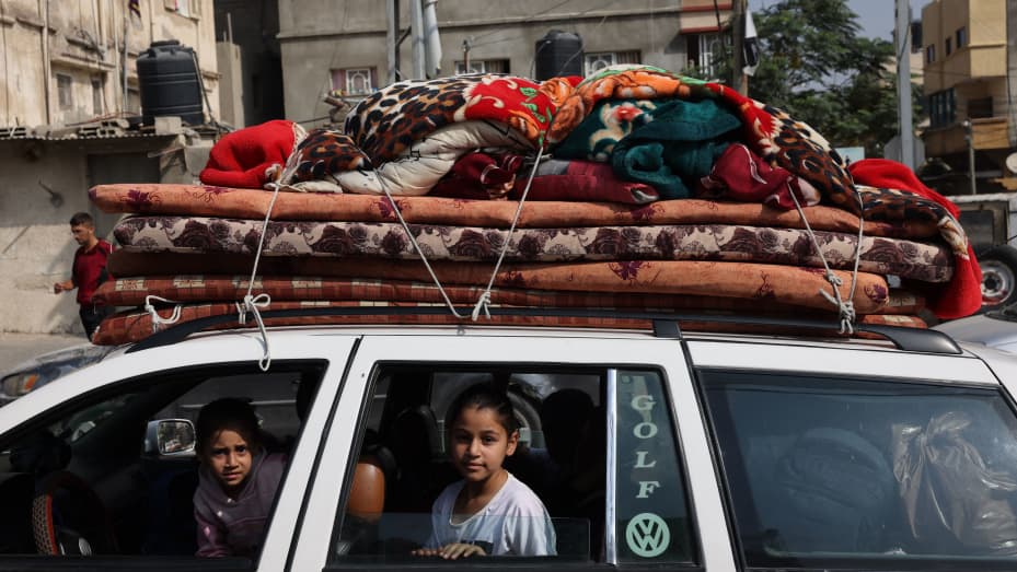 Palestinian children sit in a vehicle loaded with house hold items in Khan Yunis refugee camp, in Khan Yunis in the southern Gaza Strip on October 28 , 2023, amid the ongoing battles between Israel and the Palestinian group Hamas. Thousands of civilians, both Palestinians and Israelis, have died since October 7, 2023, after Palestinian Hamas militants based in the Gaza Strip entered southern Israel in an unprecedented attack triggering a war declared by Israel on Hamas with retaliatory bombings on Gaza. (Ph