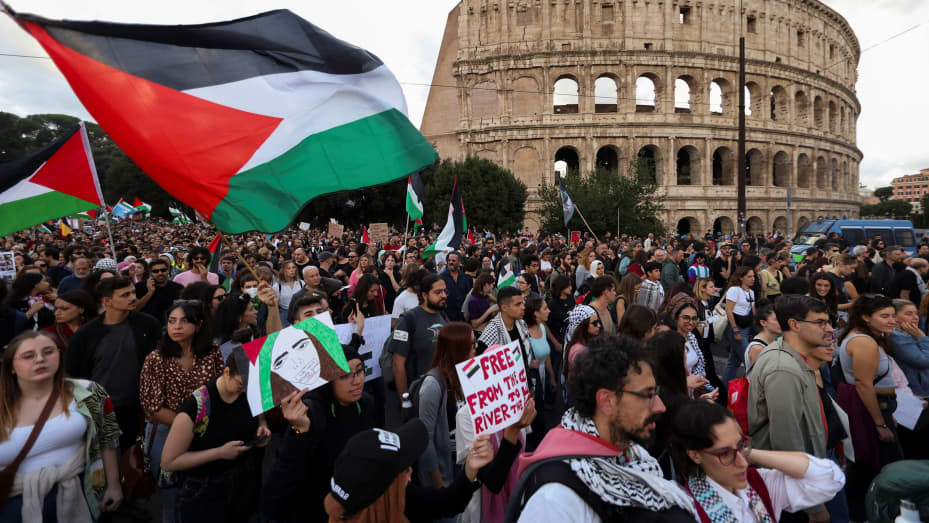 People hold Palestinian flags in front of the Colosseum during a demonstration in support of Palestinians in Gaza, as the conflict between Israel and the Palestinian Islamist group Hamas continues, in Rome, Italy, October 28, 2023. REUTERS/Yara Nardi