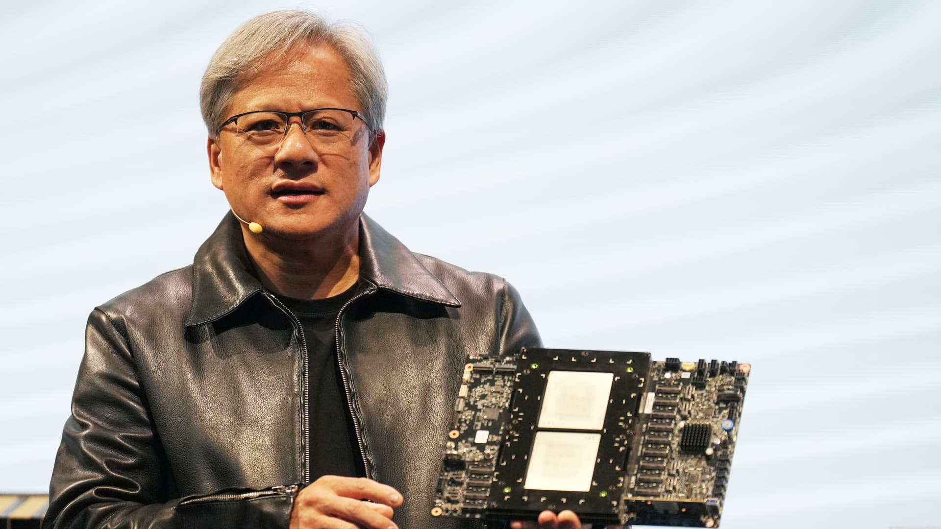 Jensen Huang, president of Nvidia, holding the Grace hopper superchip CPU used for generative AI at the Supermicro keynote presentation during Computex 2023.