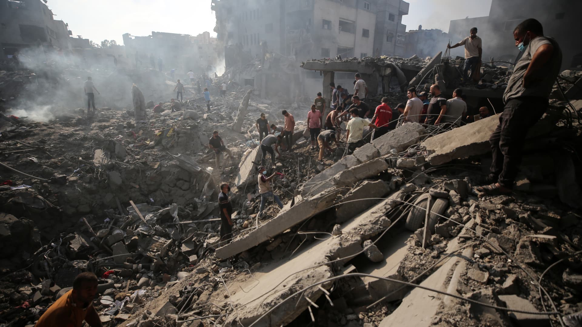 People check buildings destroyed in an Israeli strike on the Bureij refugee camp in the central Gaza Strip on November 2, 2023, as battles between Israel and the Palestinian Hamas movement continue. 