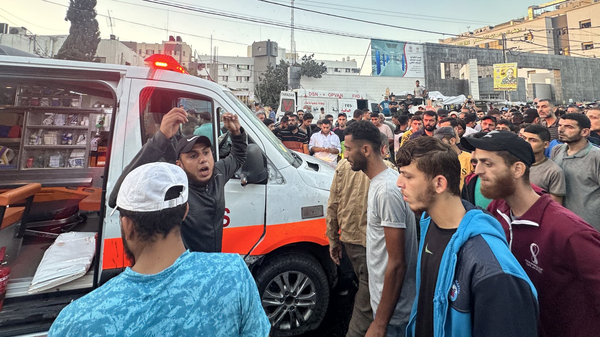 People gather around an ambulance damaged in a reported Israeli strike in front of Al-Shifa hospital in Gaza City on November 3, 2023, as battles between Israel and the Palestinian Hamas movement continue.