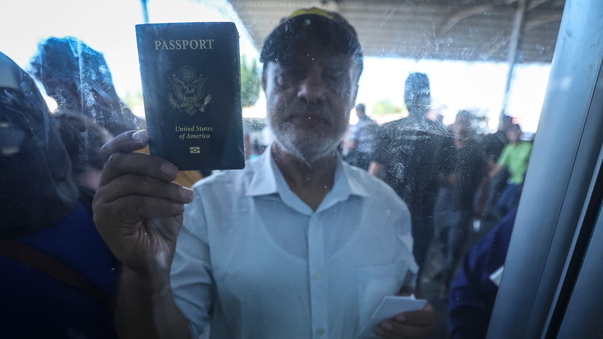 A Palestinian with dual citizenship shows his United States passport while seeking permission to leave Gaza at the Rafah border crossing into Egypt in Rafah, Gaza, on Wednesday, Nov. 1, 2023.