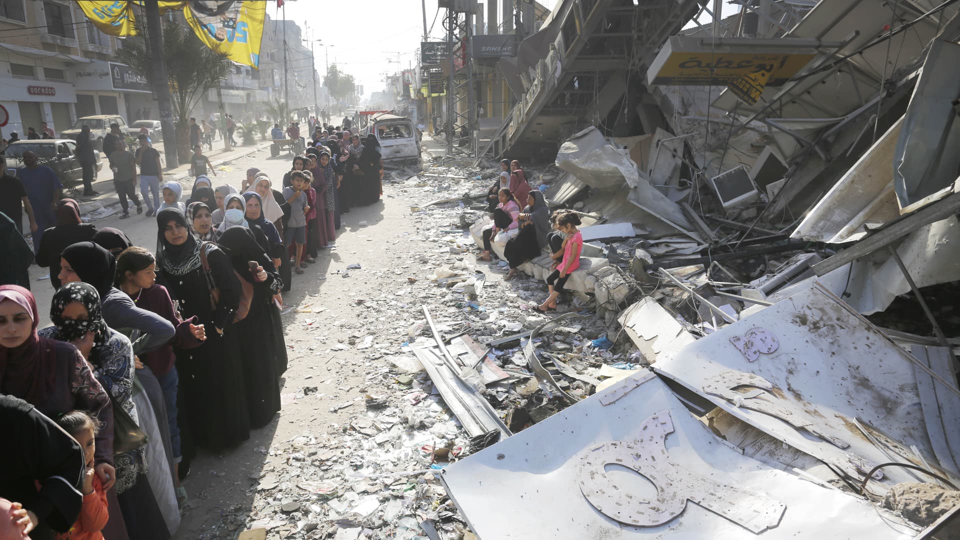 Civilians wait in front of a partially collapsed, still operational bakehouse in Nuseirat refugee camp in Deir al Balah, Gaza on November 04, 2023. The bakehouse, which is the only bakehouse in the camp, hit by Israeli forces. 
