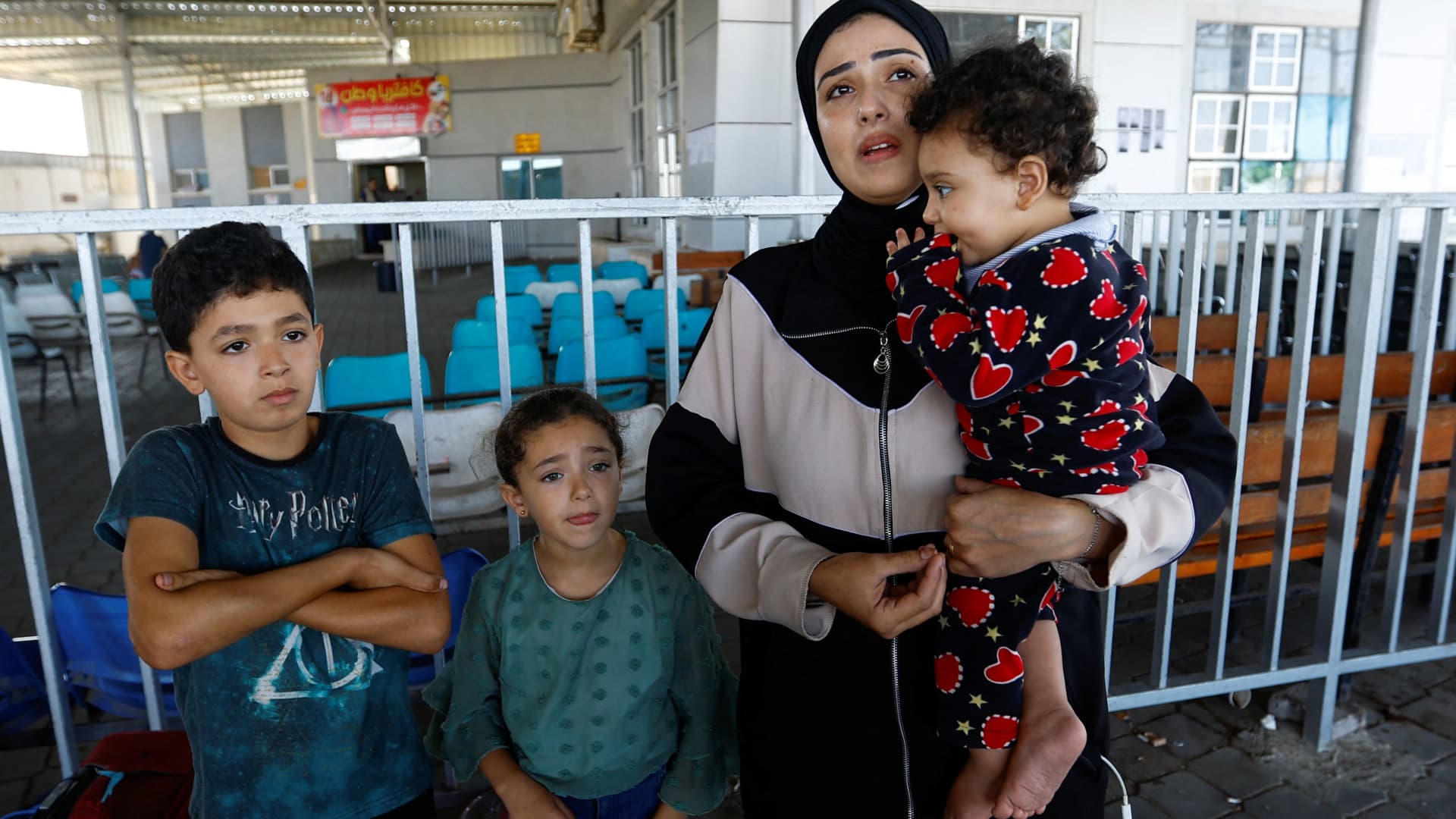 Palestinians, including foreign passport holders, wait at Rafah border crossing after evacuations were suspended following an Israeli strike on an ambulance, in Rafah in the southern Gaza Strip, November 5, 2023. 