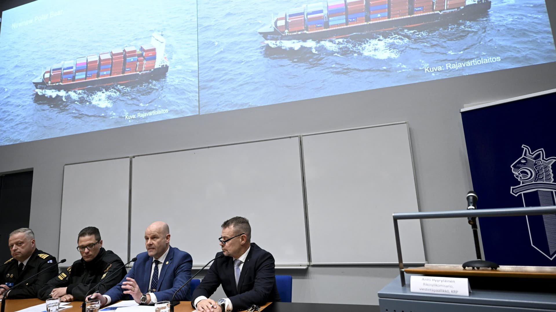 The commanding officer of the Finnish Navy Toni Joutsia (L to R), lieutenant commander of the Finnish Border Guard Markus Paljakka, the detective inspector of the National Bureau of Investigation Risto Lohi and the Chief of National Bureau of Investigation Robin Lardot attend a joint press conference of the investigation of the possible attack on the Balticconnector gas line on October 8, 2023 between Finland and Estonia at the headquarters of the National Bureau of Investigation in Vantaa, Finland on October 24, 2023. The screen shows Finnish Border Guard's photo of a Hong Kong -registered cargo ship 'Newnew Polar Bear', which was spotted moving close to the Balticconnector gas line.Finnish police said a Chinese ship was the focus of their investigation into suspected sabotage of the Balticconnector pipeline. (Photo by Heikki Saukkomaa / Lehtikuva / AFP) / Finland OUT (Photo by HEIKKI SAUKKOMAA/Lehtikuva/AFP via Getty Images)