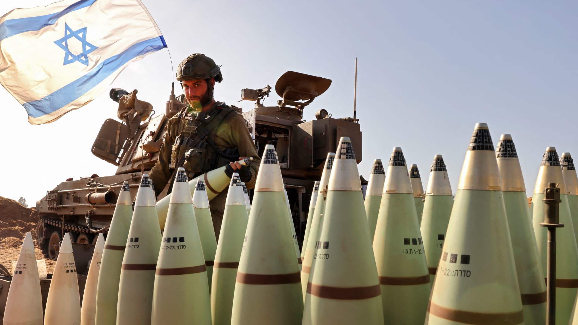 An Israeli soldier arranges artillery shells at a position near the border with the Gaza Strip in southern Israel on November 6, 2023.