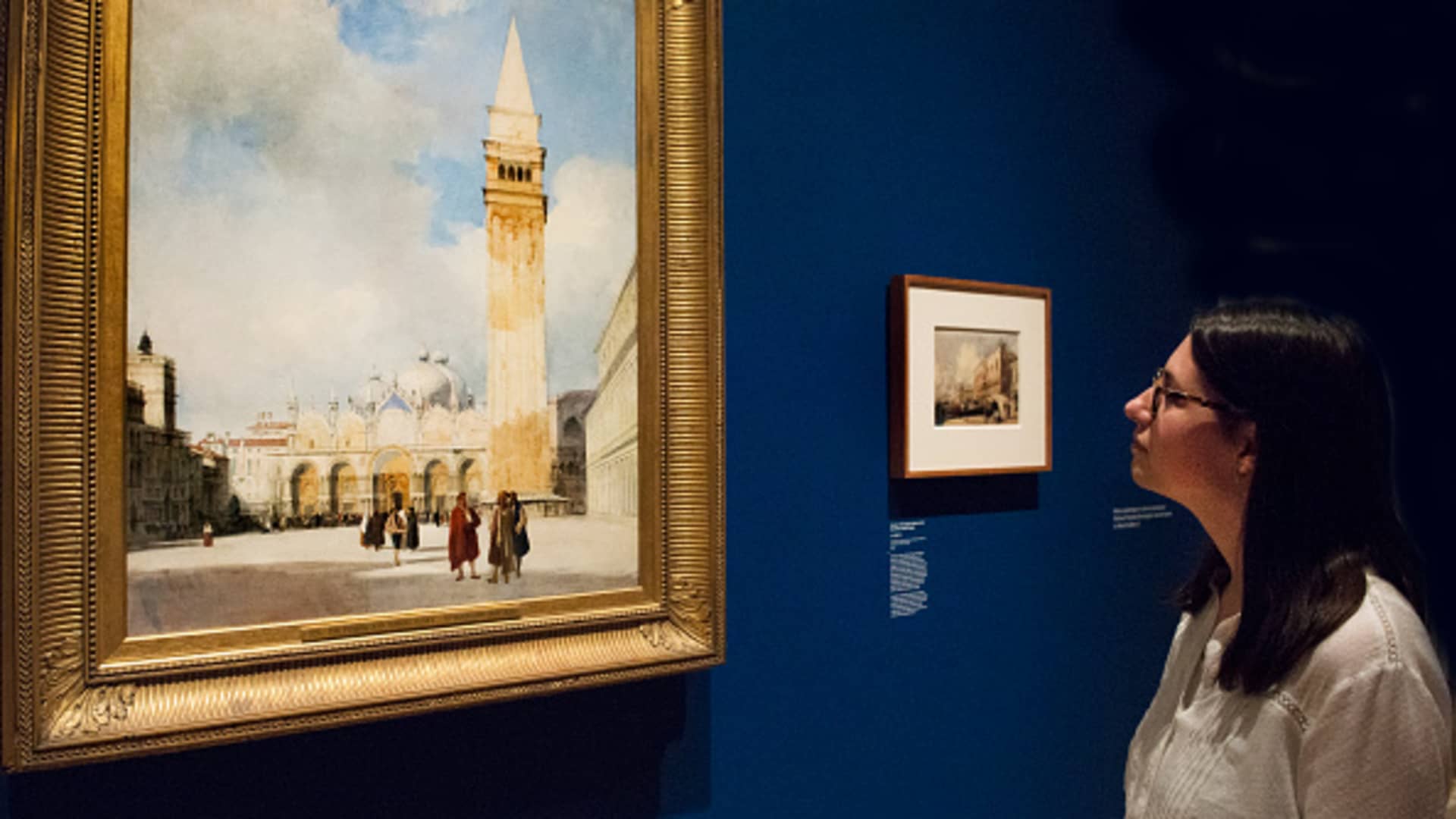 A woman views 'Venice: the Piazza San Marco' by British watercolor artist Richard Parkes Bonington at the Wallace Collection, London, in September 2023.