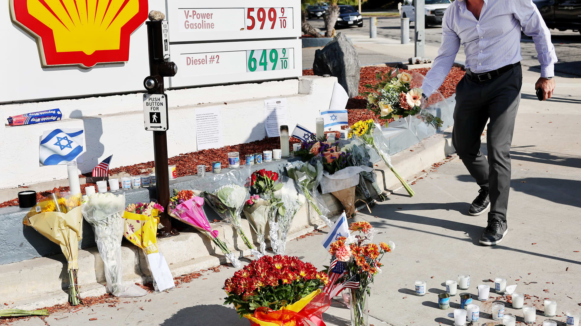 A person places flowers at a makeshift memorial at the site of an altercation between 69-year-old Paul Kessler, who was Jewish, and pro-Palestinian protestor on November 7, 2023 in Thousand Oaks, California.