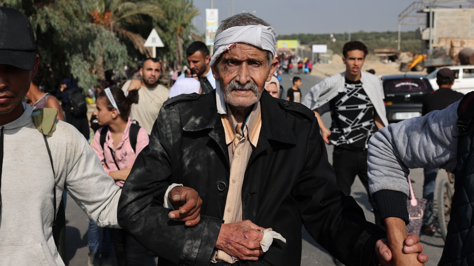 Palestinians fleeing Gaza City towards the southern areas walk on a road on November 8, 2023, amid the ongoing battles between Israel and the Palestinian Islamist group Hamas. 