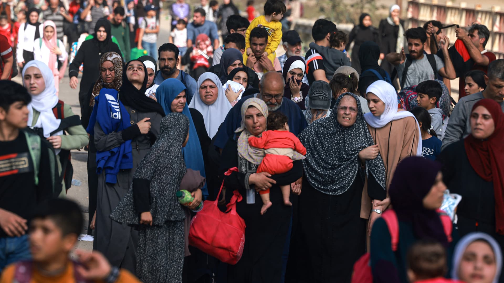 Palestinians fleeing Gaza City and other parts of northern Gaza towards the southern areas, walk on a road on November 8, 2023 amid the ongoing battles between Israel and the Palestinian Islamist group Hamas.