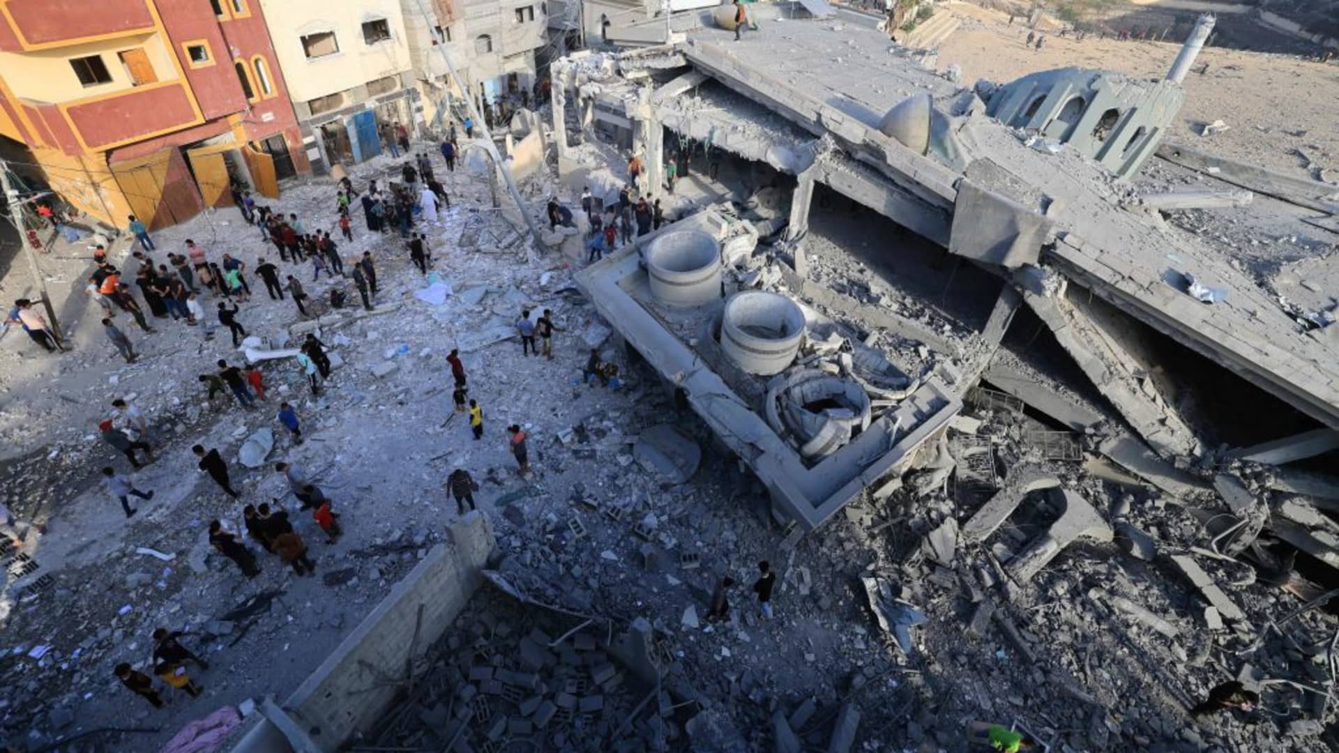 Palestinians collect the Qorans near destroyed Khalid ibn al-Walid Mosque after Israeli airstrikes in Khan Younis, Gaza on November 08, 2023. 