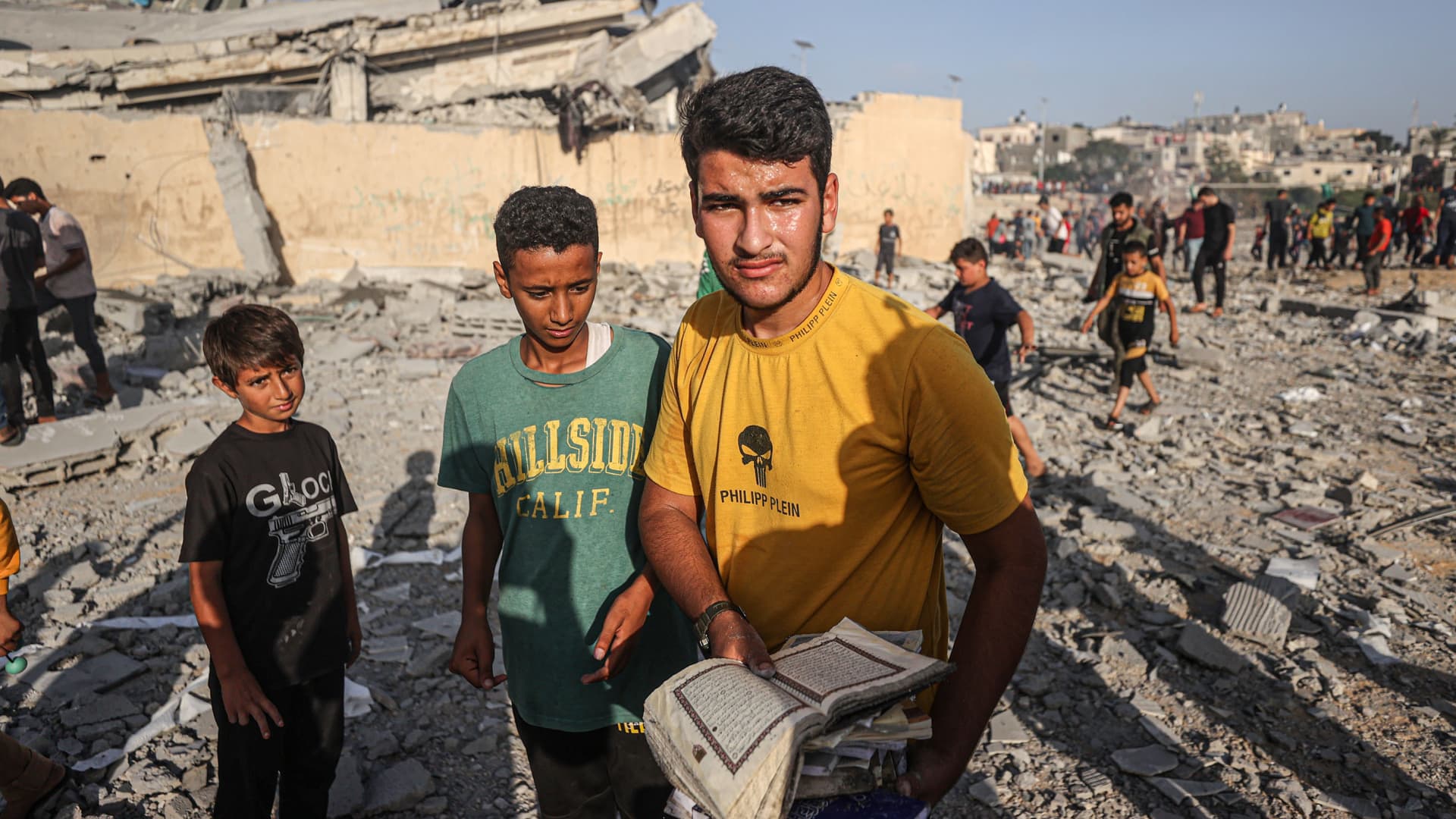 Palestinians collect the Qorans near destroyed Khalid ibn al-Walid Mosque after Israeli airstrikes in Khan Younis, Gaza on November 08, 2023. 