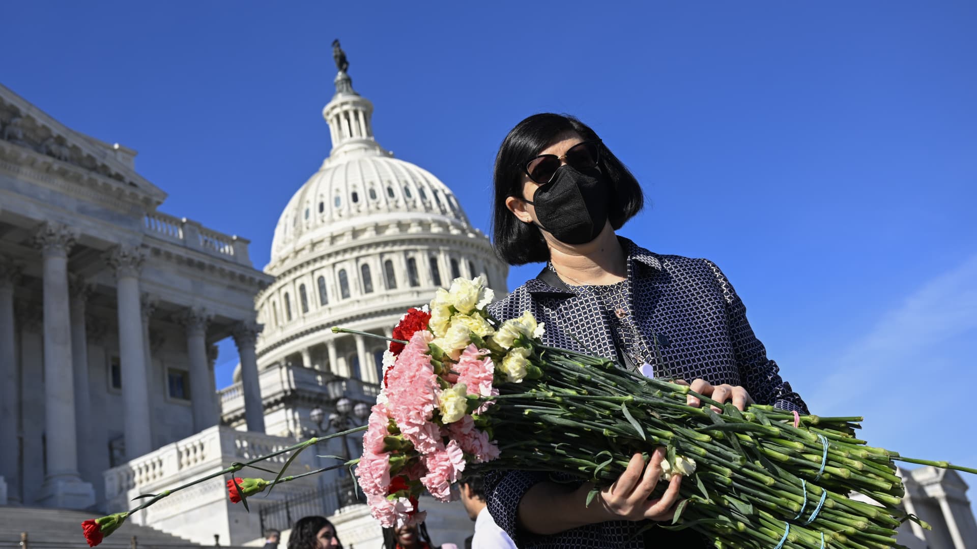 Congressional staff lay down roses and carnations on the stairs in front of the congress building for those who lost their lives in Gaza due to Israeli attacks as they unfurl banner demanding a ceasefire on November 08, 2023 in Washington D.C, United States. 