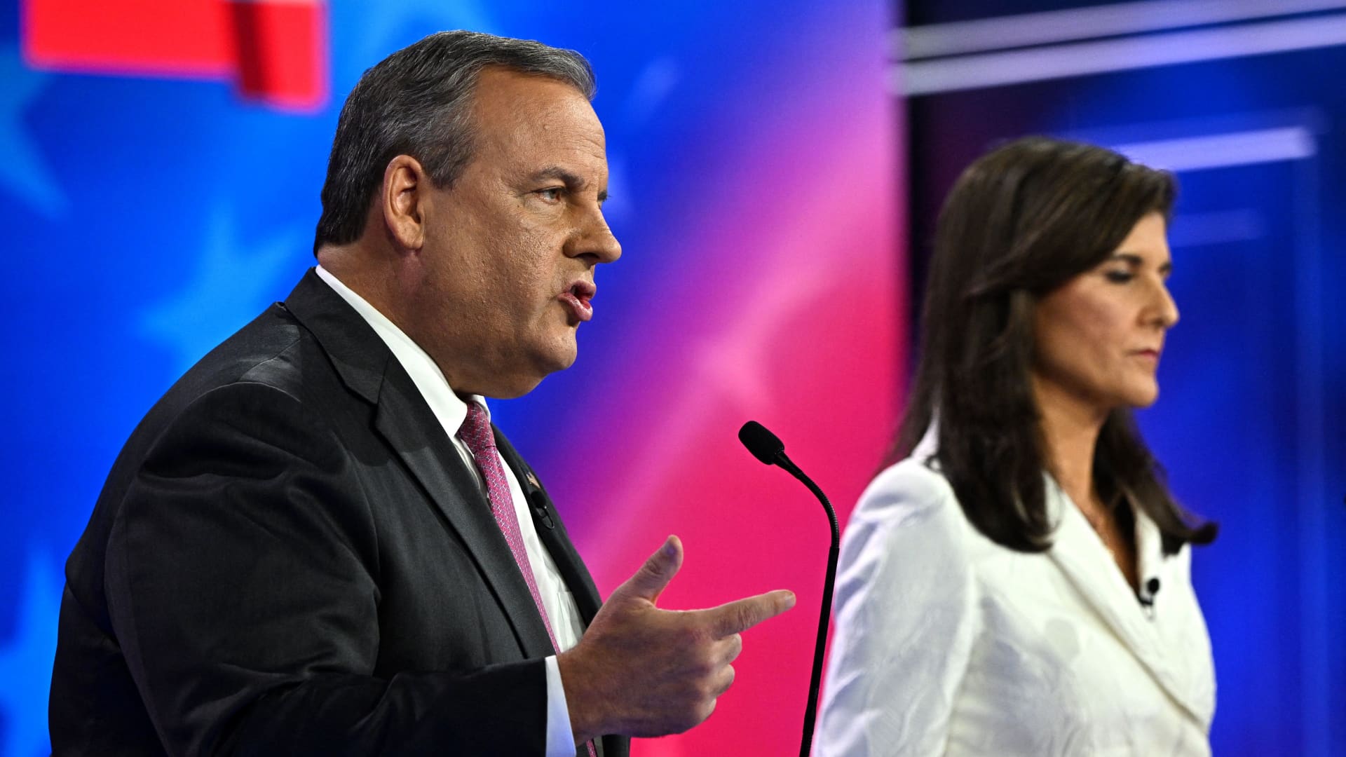 Former Governor of New Jersey Chris Christie (L) speaks alongside former Governor from South Carolina and UN ambassador Nikki Haley during the third Republican presidential primary debate at the Knight Concert Hall at the Adrienne Arsht Center for the Performing Arts in Miami, Florida, on November 8, 2023.
