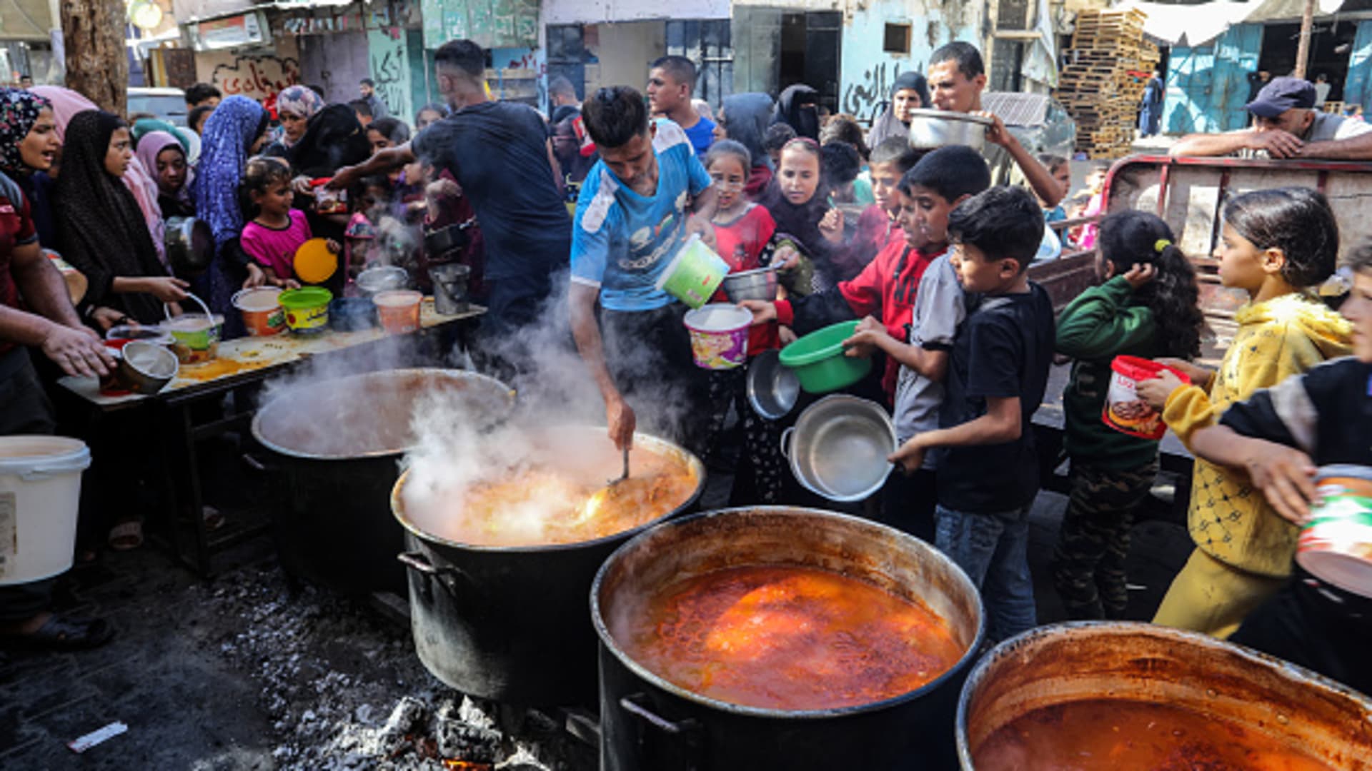 Needy Palestinians line up for food prepared by volunteer Palestinians in the city of Rafah, Gaza on November 9, 2023. 