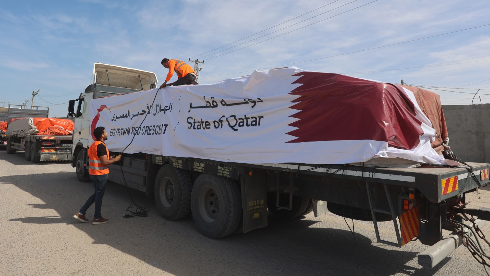 Employees from the Palestinian Red Crescent Society receive the aid convoy from Egyptian side, at Rafah border. United Nations (UN) agences are expected to deliver humanitarian aid to those in need in various areas of the Gaza Strip, Gaza government media office said on Saturday. 