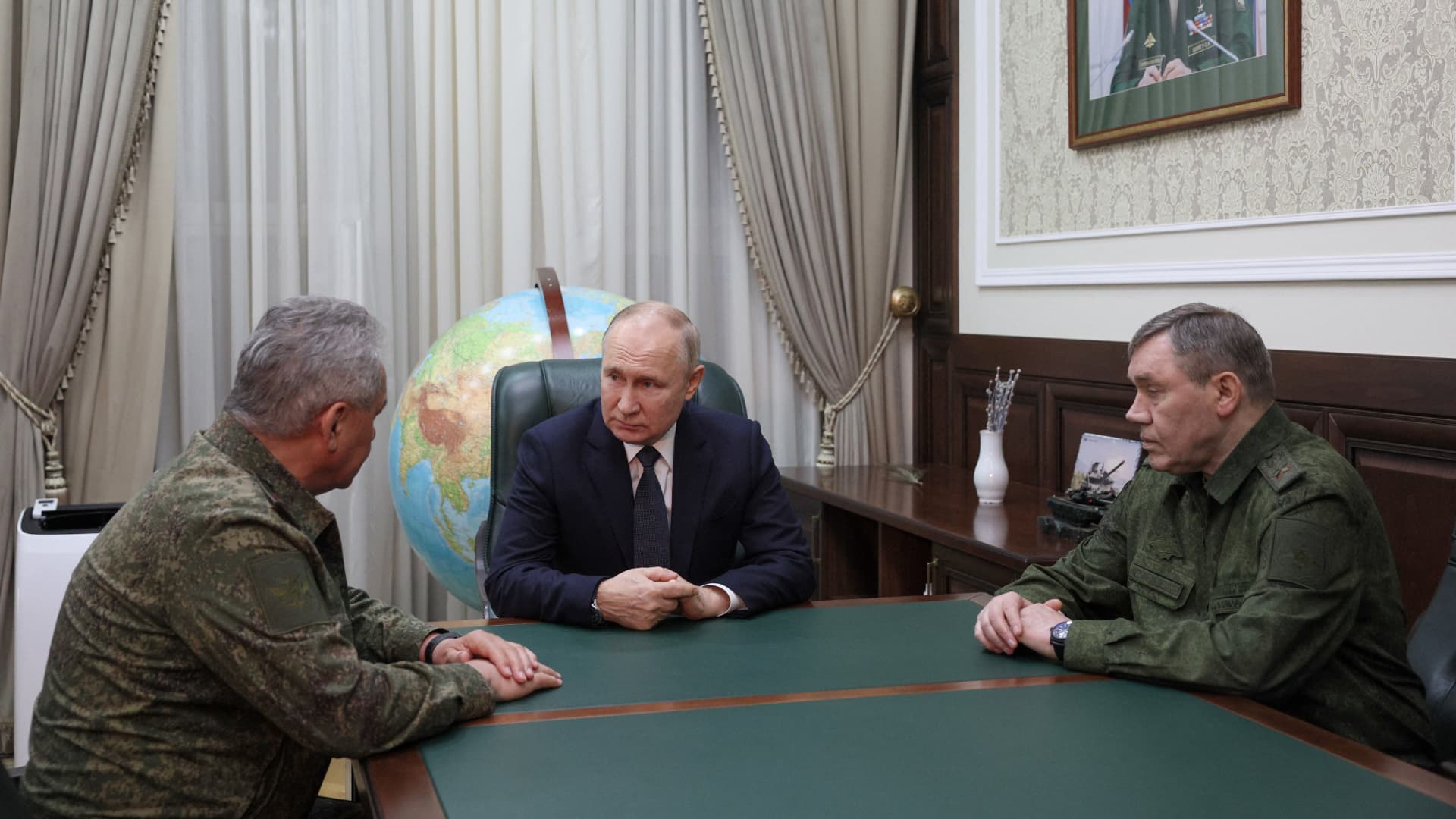 Russian President Vladimir Putin in a meeting with Russian Defense Minister Sergei Shoigu (left) and Russian Army chief of staff, Valery Gerasimov, during a visit to military headquarters in Rostov-on-Don.