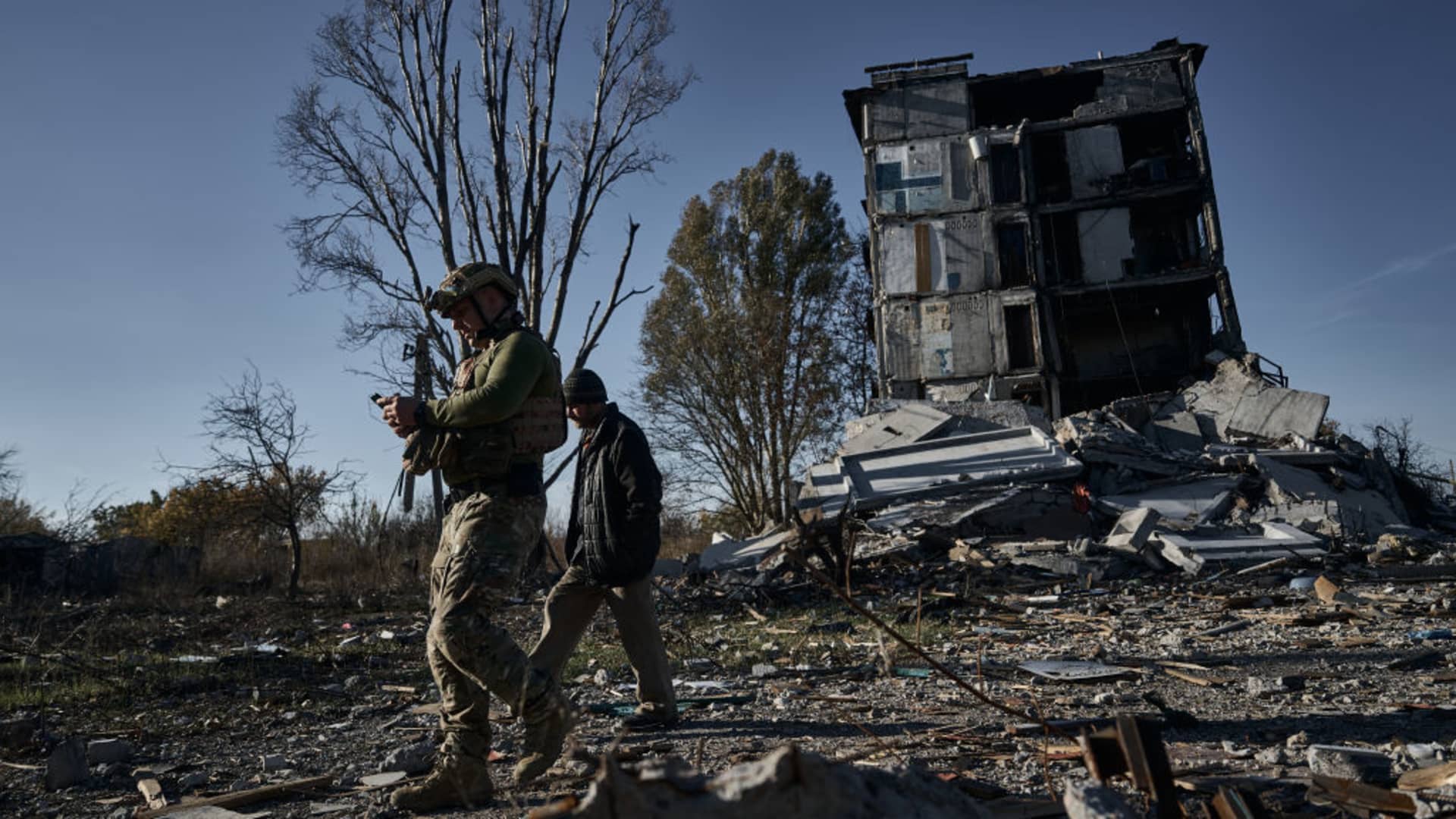 Police officer Gennady convinces a local resident who lives in a dilapidated house to evacuate on October 30, 2023 in Avdiivka, Ukraine.