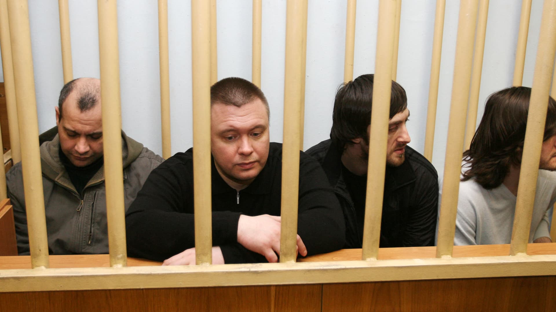 The four suspects in the murder case of Russian investigative journalist Anna Politkovskaya, from left, Sergei Khadzhikurbanov, Pavel Ryaguzov, Ibragim Makhmudov and Dzhabrail Makhmudov sit inside the defendants' cage at a Moscow court on February 18, 2009. The jury in the trial of the 2006 murder of Politkovskaya will retire on February 19 to consider a verdict against the accused, the judge said.AFP PHOTO / ALEXEY SAZONOV (Photo by Alexey SAZONOV / AFP) (Photo by ALEXEY SAZONOV/AFP via Getty Images)