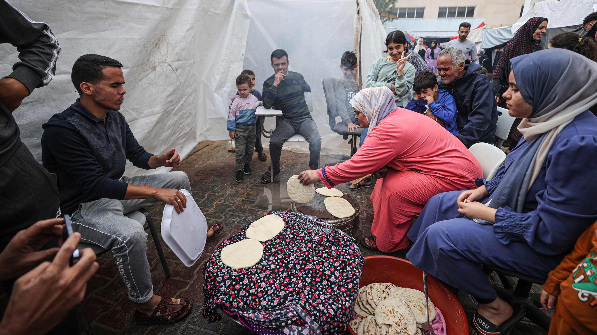 People make bread in the United Nations Relief and Works Agency (UNRWA) refugee camp located in Khan Younis, Gaza where displaced Palestinian families take shelter as Israeli attacks on Gaza continue on November 15, 2023. 
